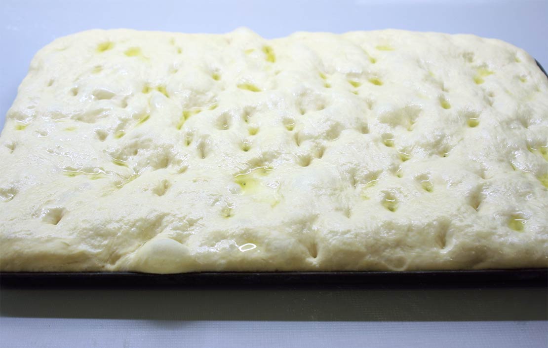the risen, shaped foccacia, ready to be baked