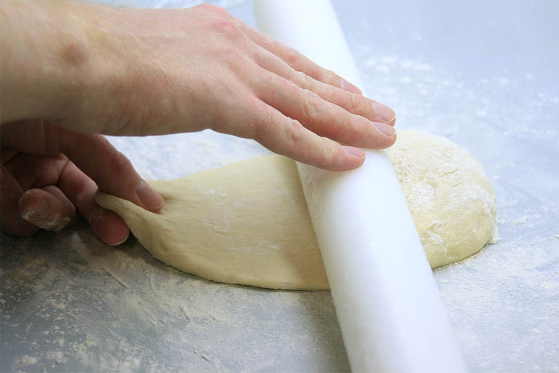 rolling out the naan bread