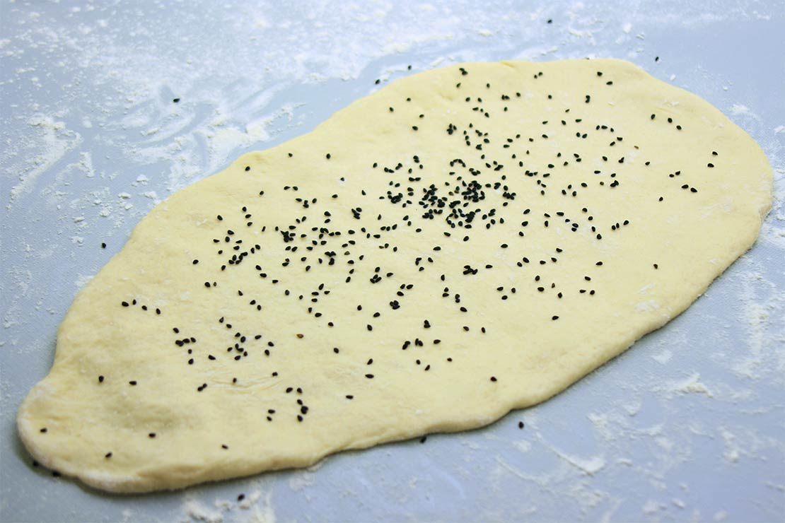 the shaped naan with the onion seeds on