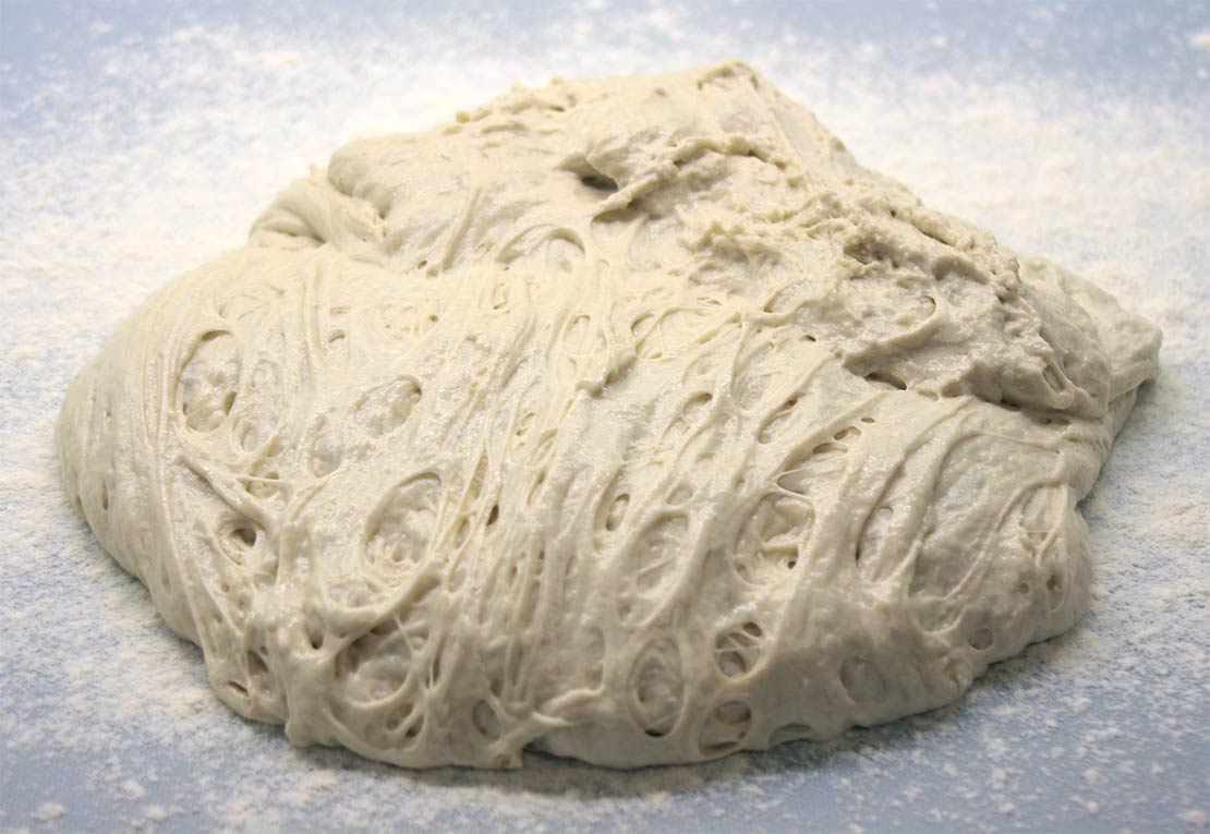 tipping the dough onto a floured work surface