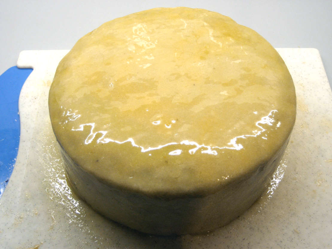 Painting the marzipan with apricot glaze