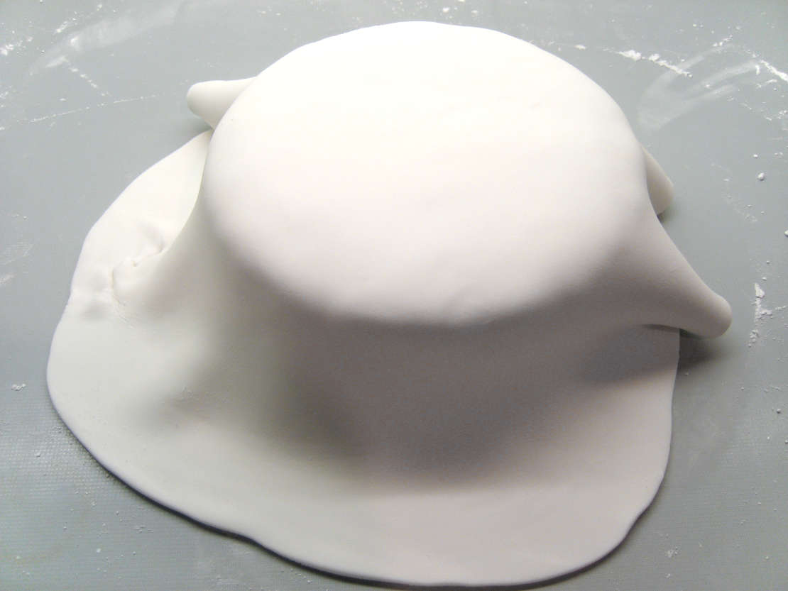 Draping the icing over the cake
