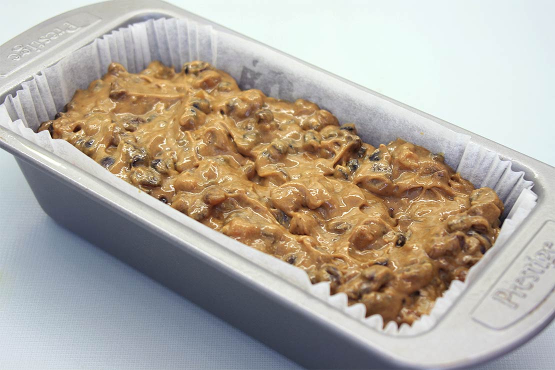 the fruitcake batter in the loaf tin