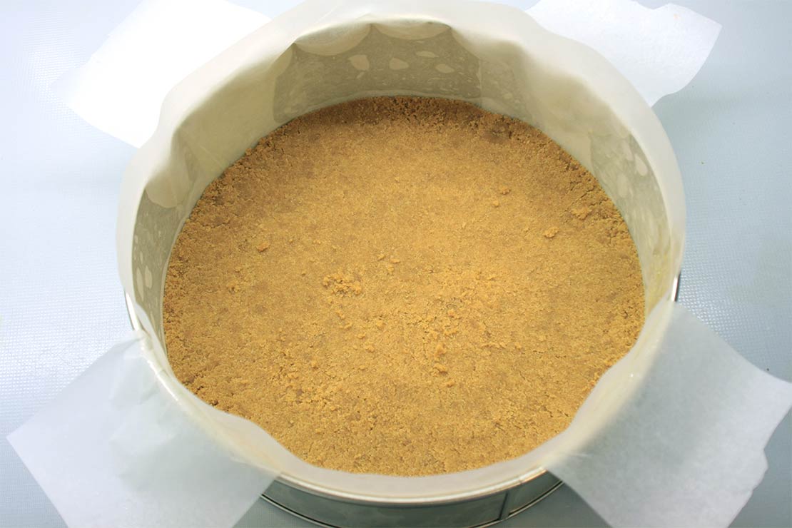 the biscuit base in the lined tin
