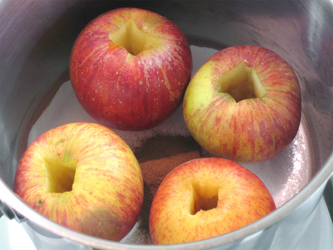 the apple poaching ingredients in a pan