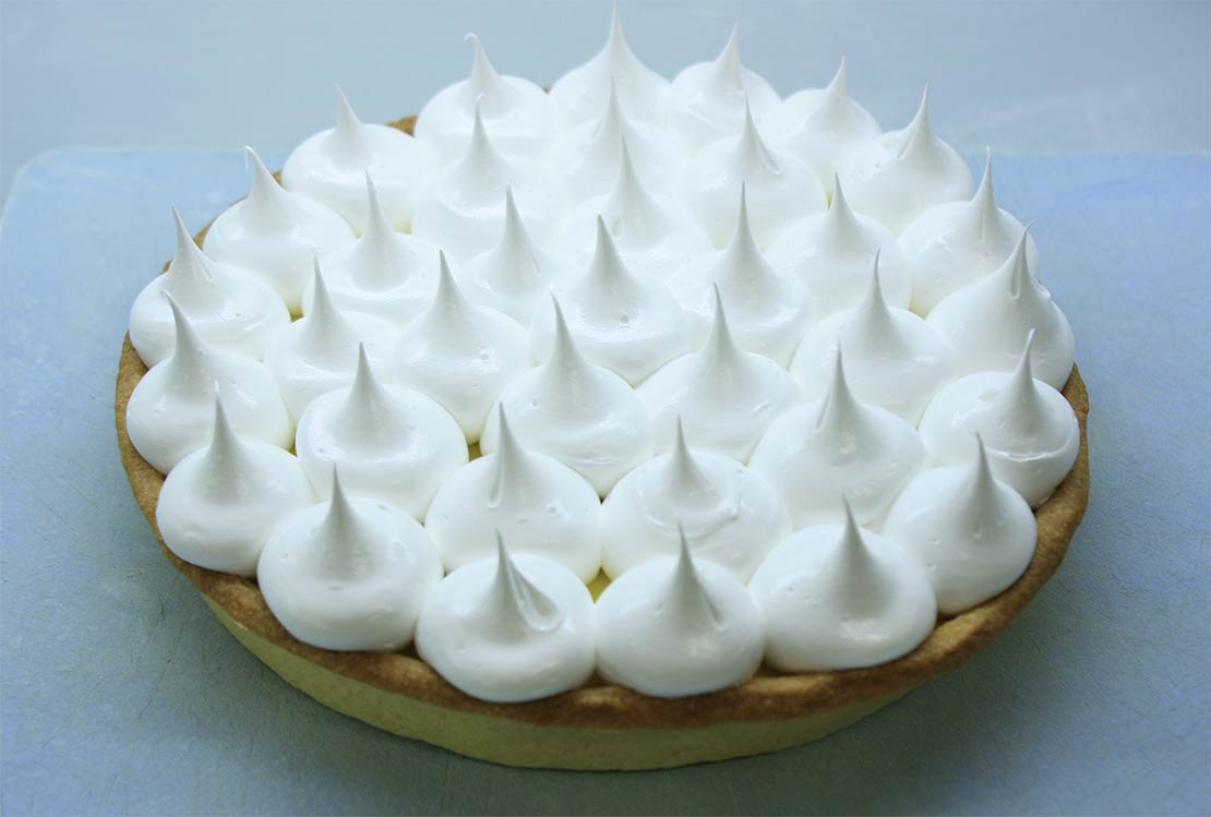 the meringue piped on top of the lemon meringue pie