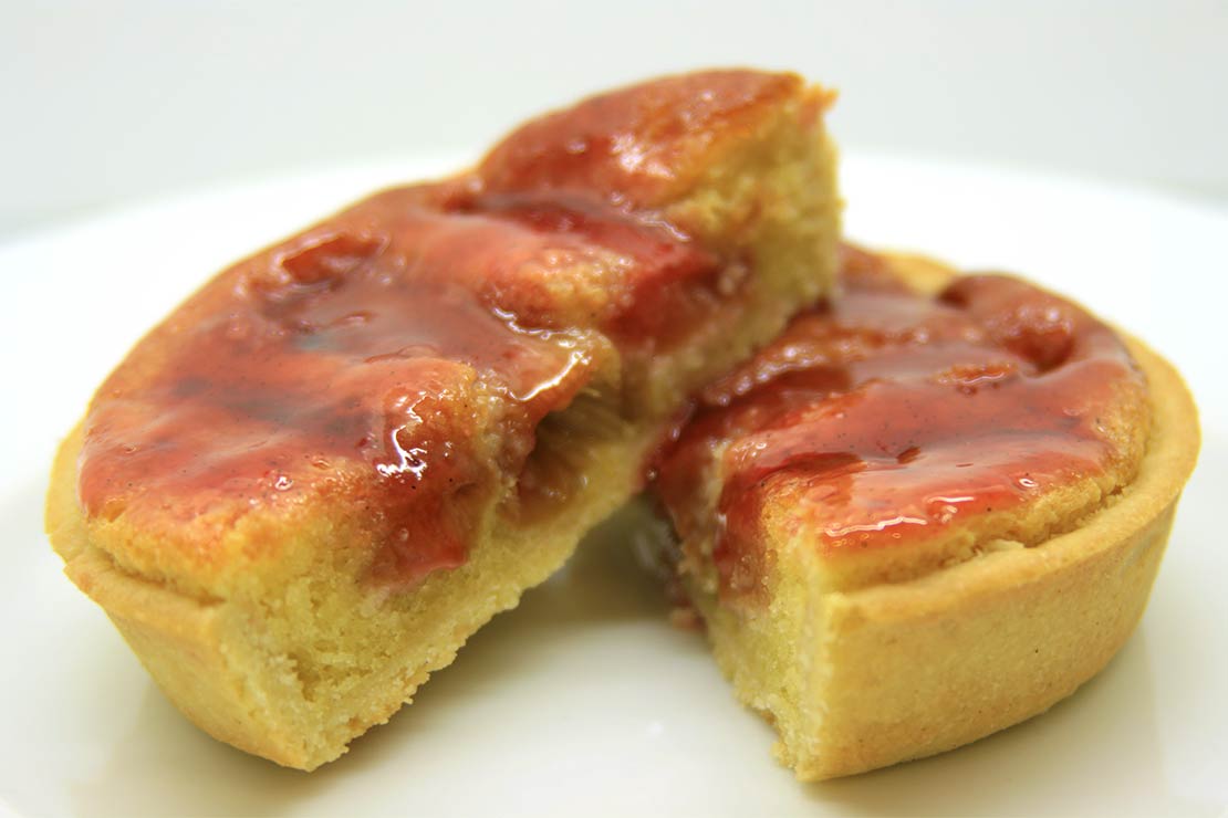 the finished rhubarb tart, cut in half and placed at a jaunty angle