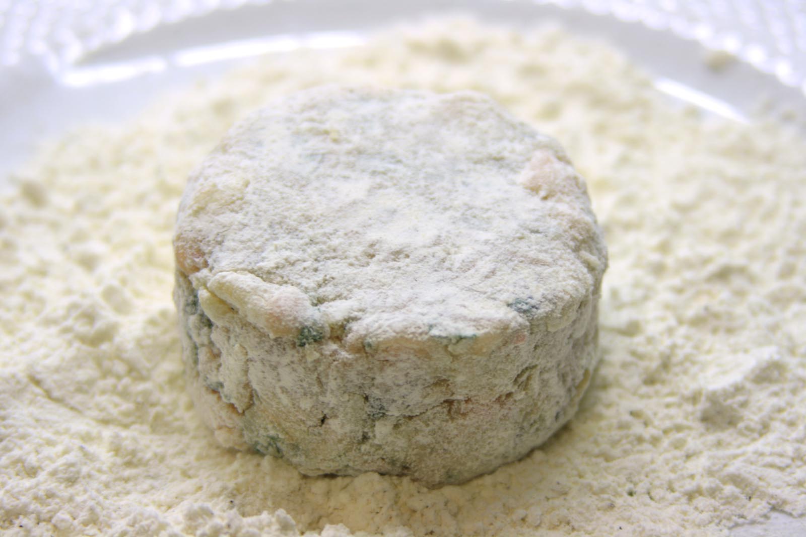 coating the fish cakes in flour