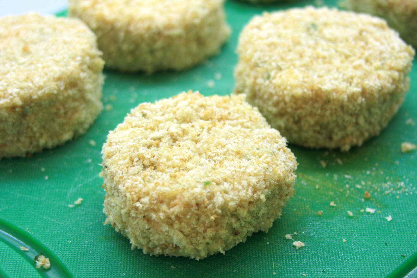 coating the fish cakes in breadcrumbs