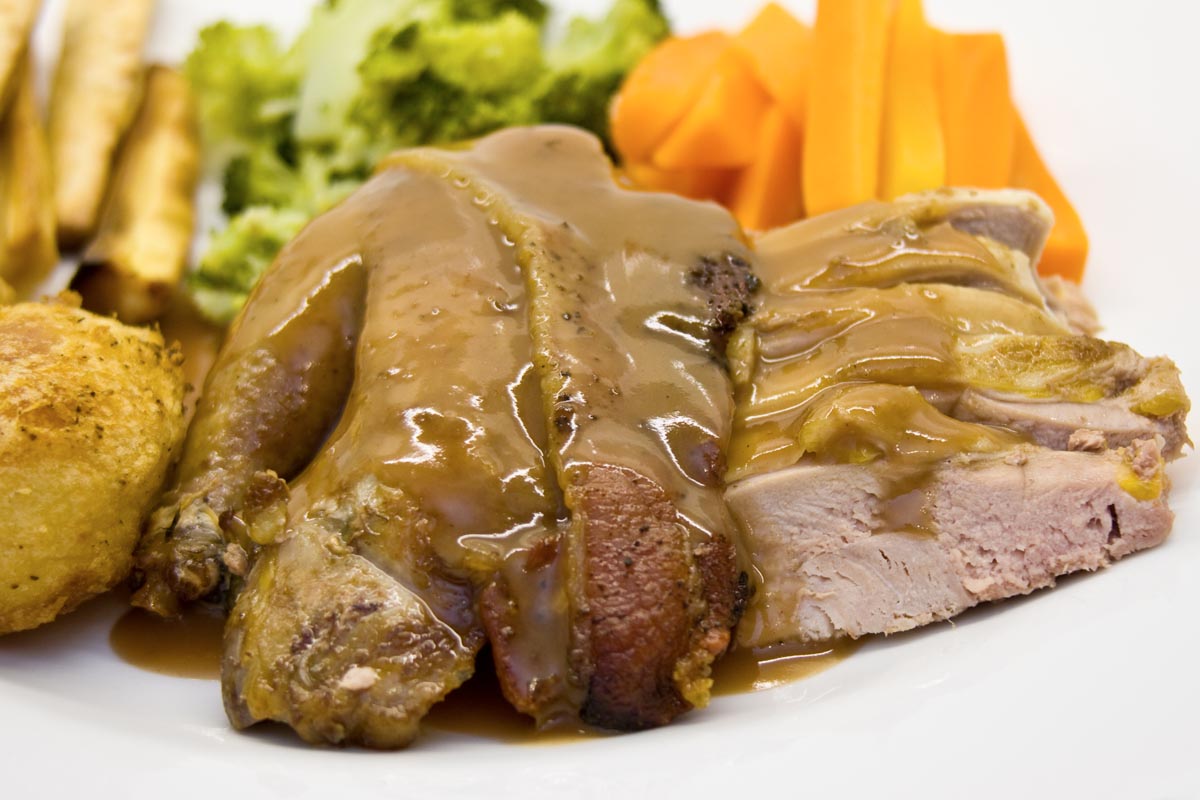 a plate of the finished roast pheasant and sauce