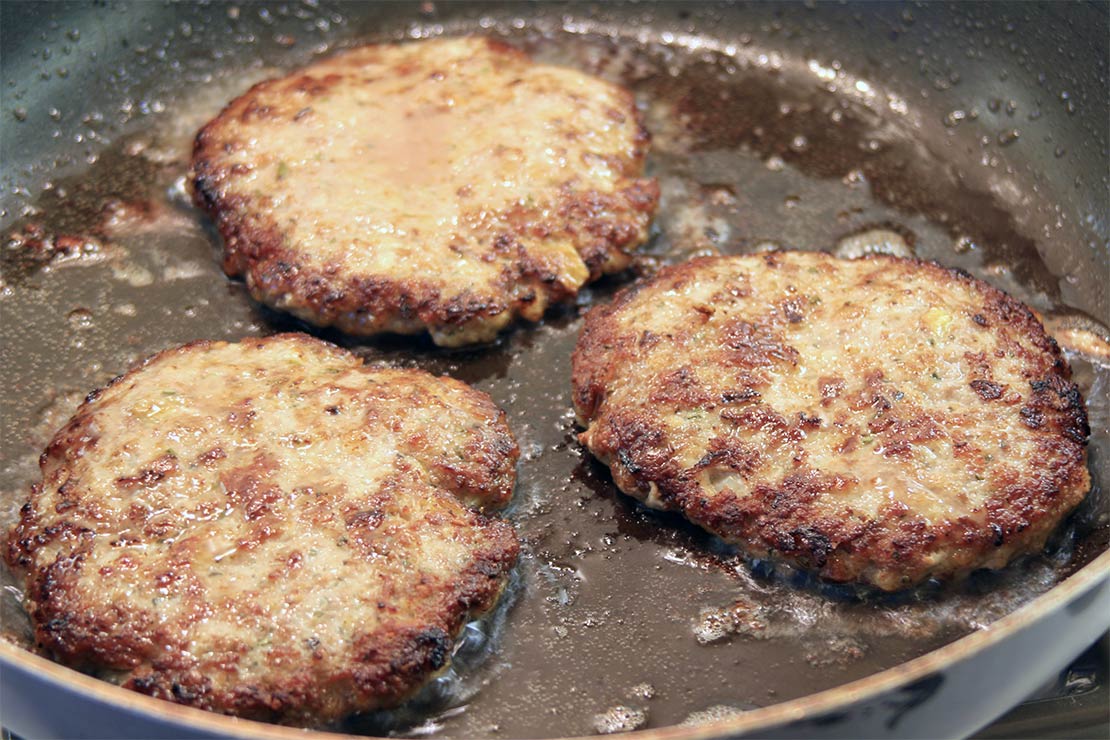 frying the lamb burgers