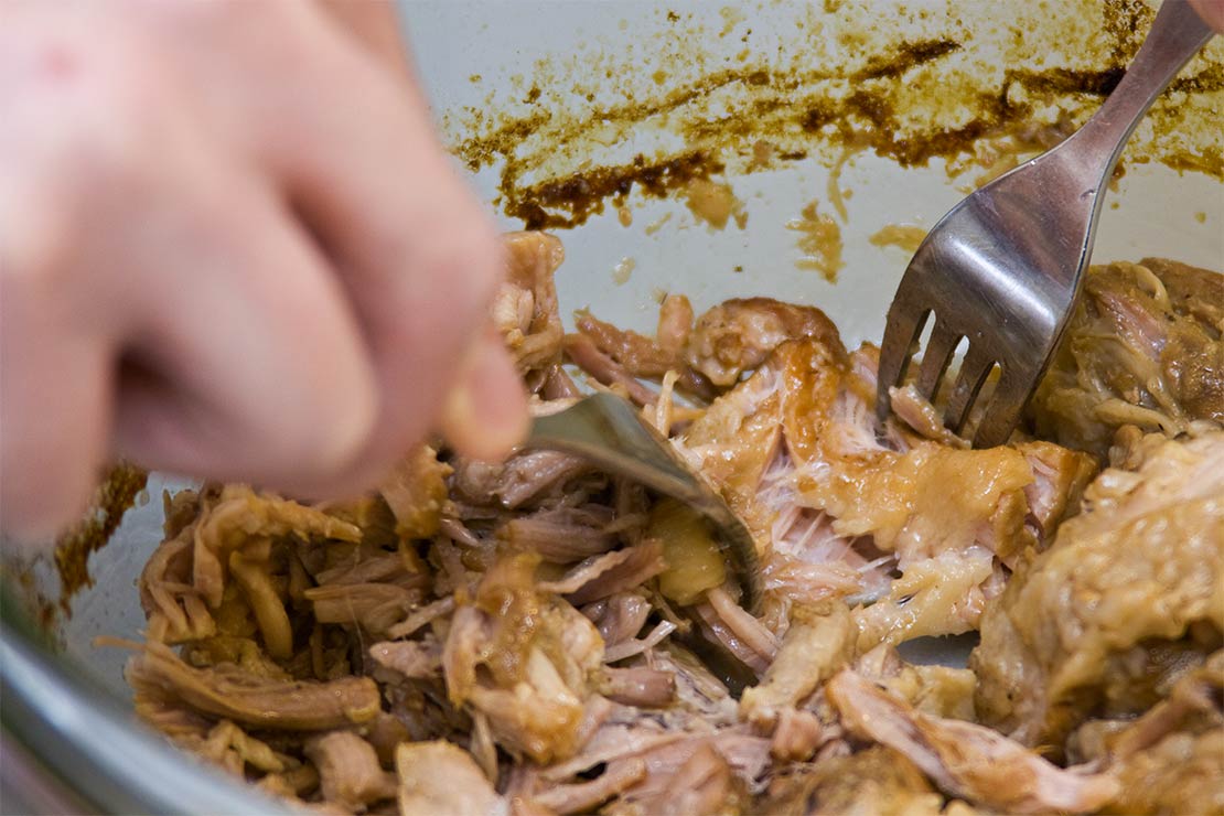 shredding the pork with two forks
