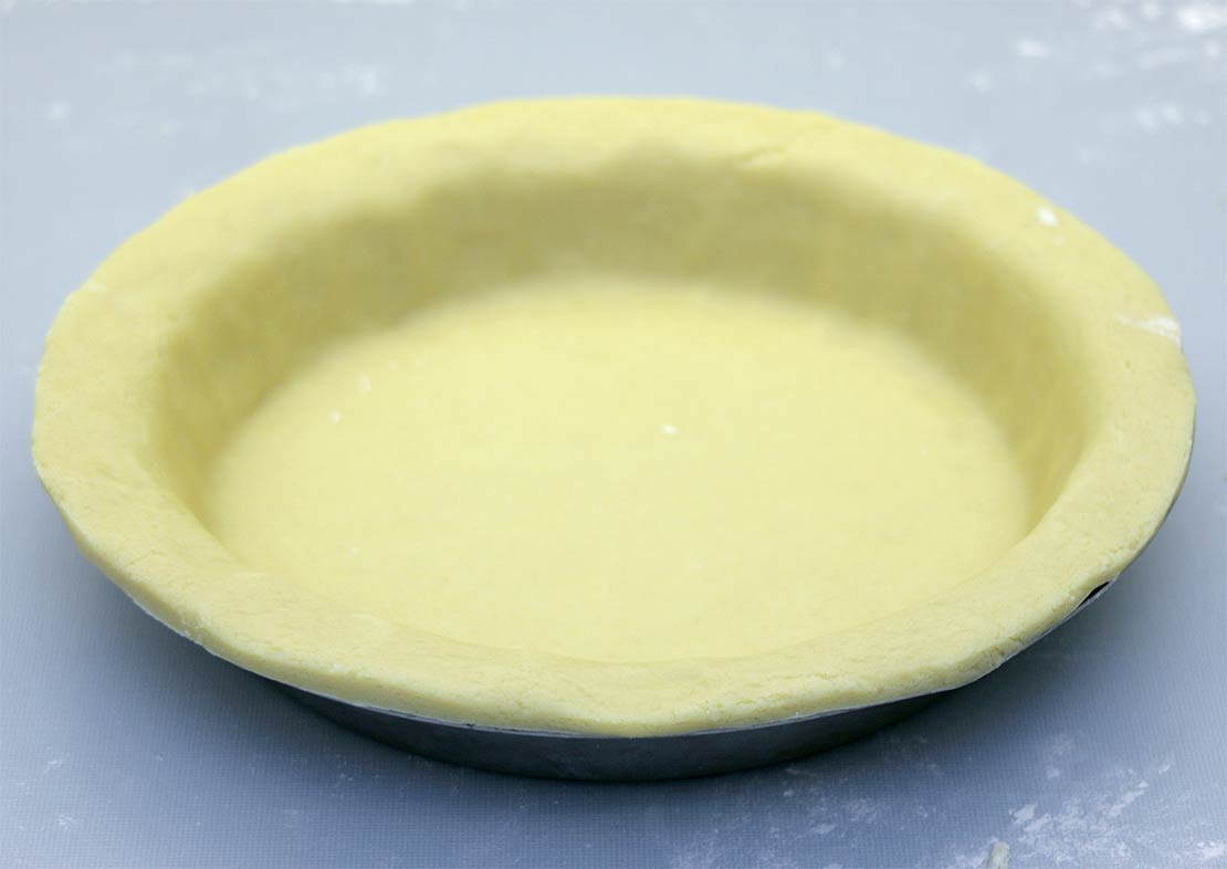 lining the pie dish with pastry