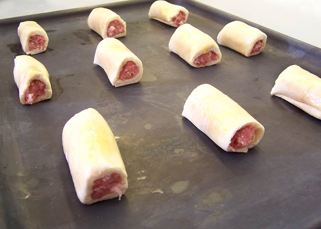 cutting the sausage rolls