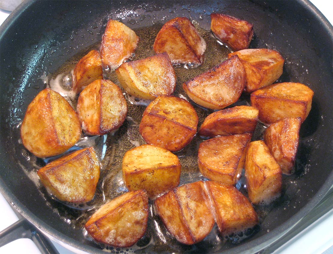 the cooked potatoes in the pan
