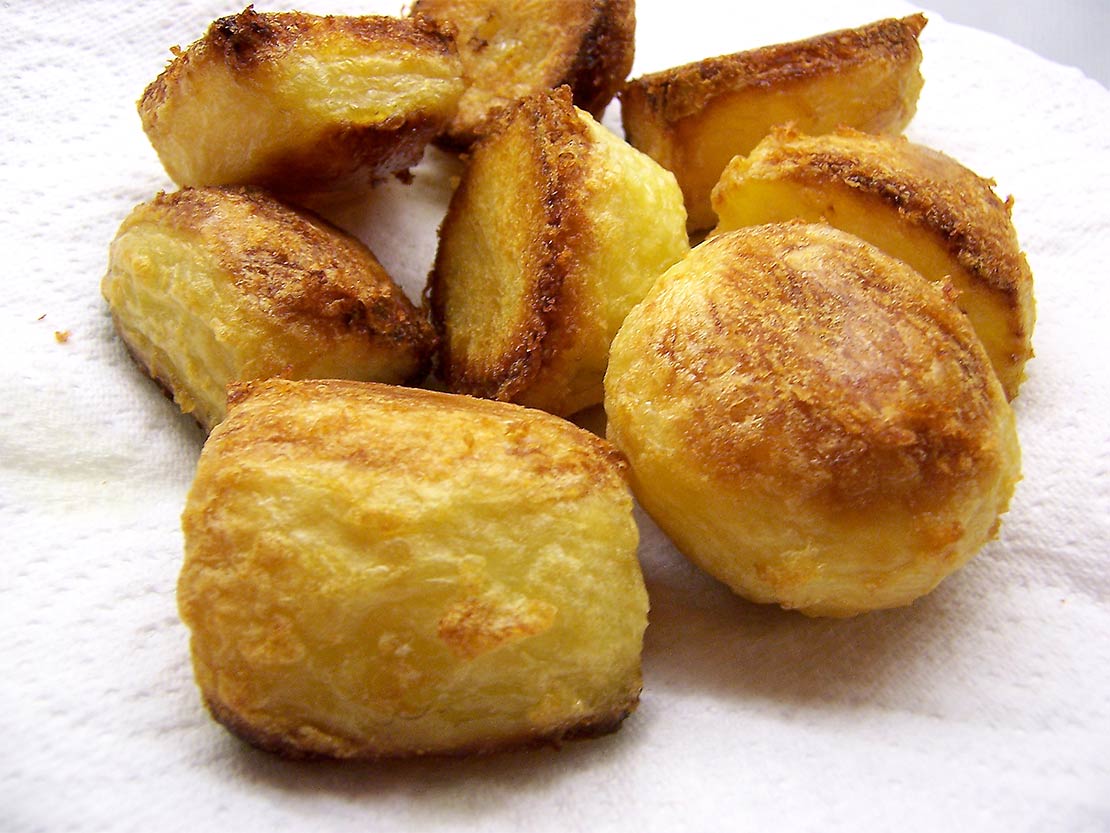 draining the cooked potatoes