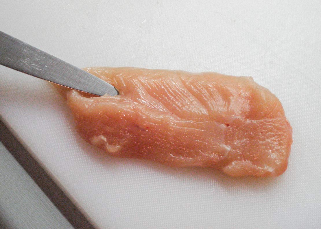 Preparing to cut the cavity into the chicken breast