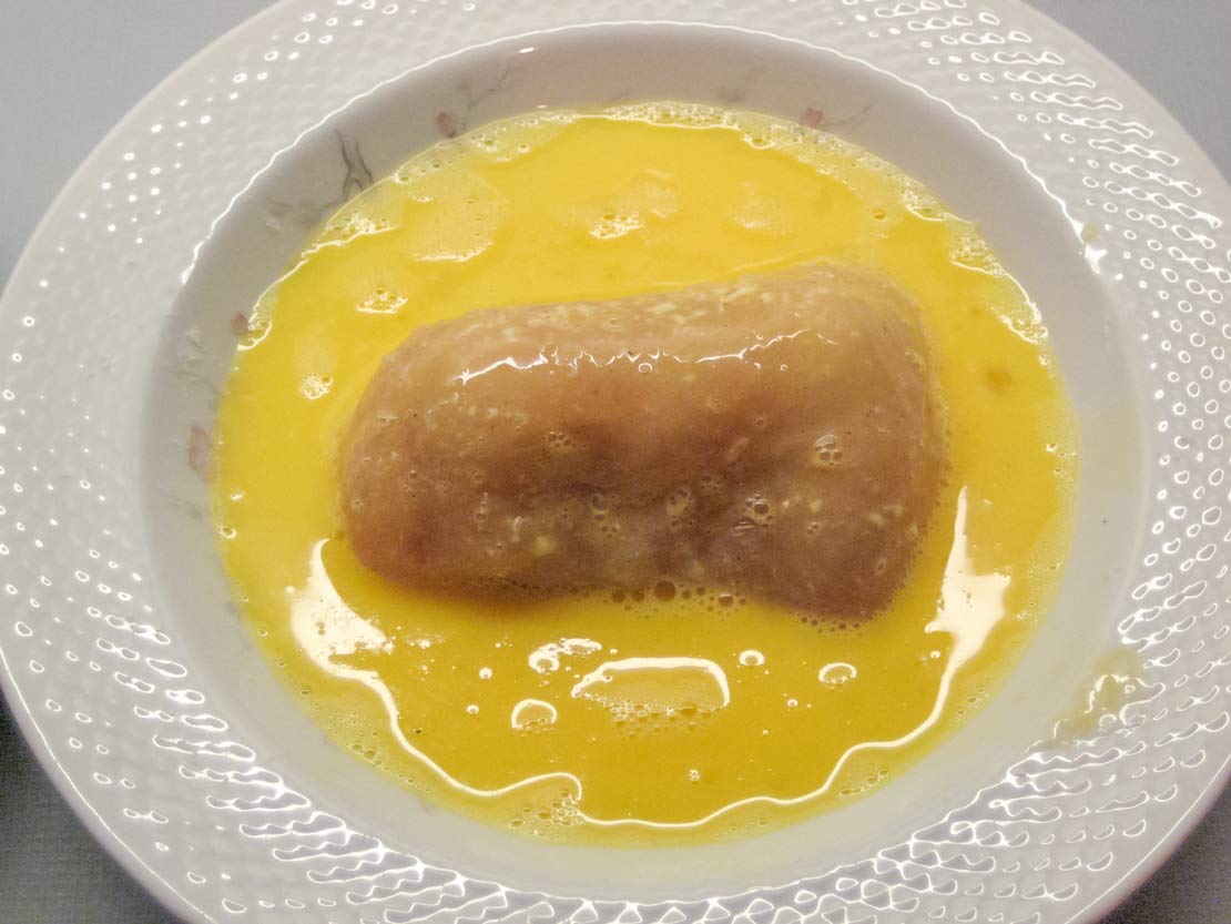 rolling the Kiev in beaten egg
