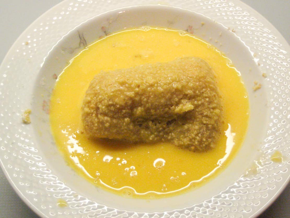 Coating the Kiev in beaten egg a second time