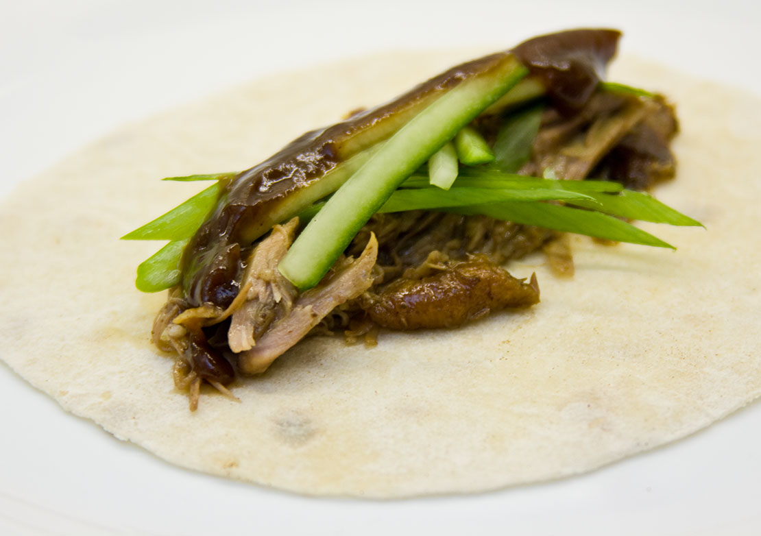 a finished duck pancake, waiting to be rolled