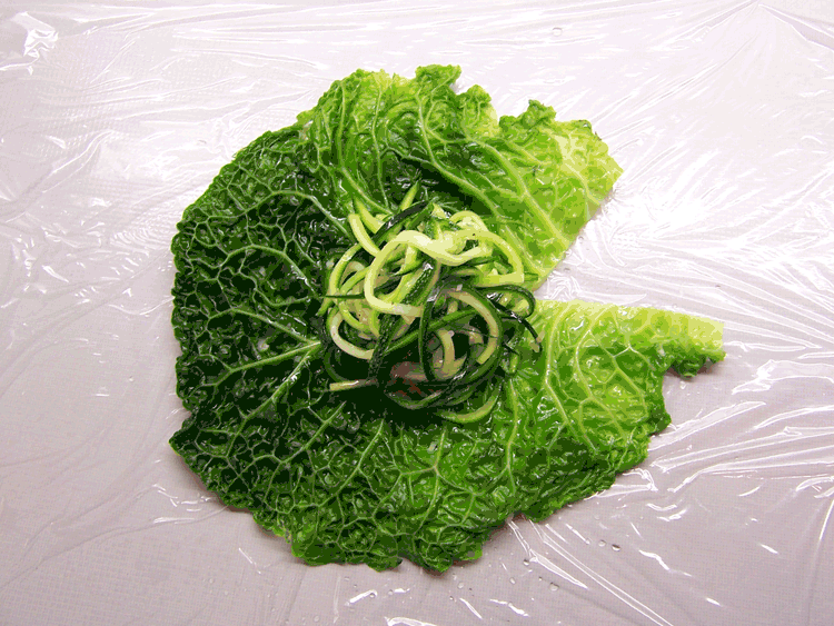 Placing the stuffing onto the cabbage leaves
