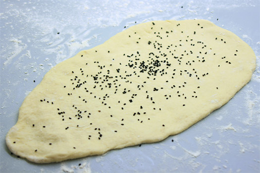 the shaped naan with the onion seeds on