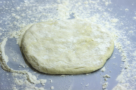 roughly shaping the pizza dough