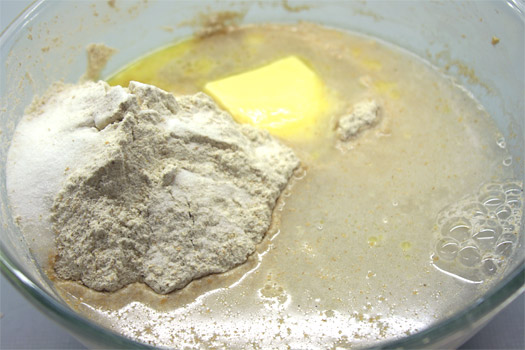 adding the bread ingredients to the starter