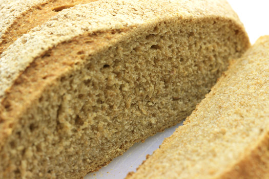 a close up of the finished, sliced wholemeal bread loaf