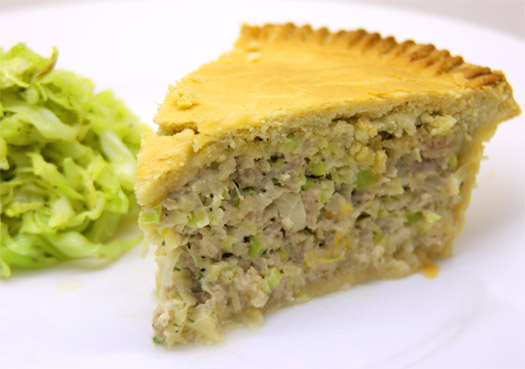 a slice of the finished sausage and leek pie