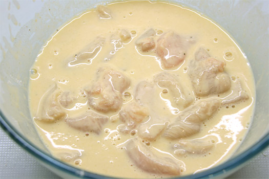 the chicken pieces in the batter